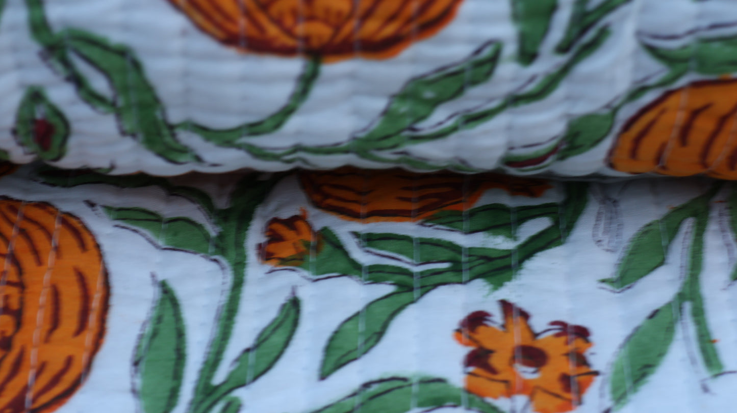 Close-up of fabric with orange and green floral pattern