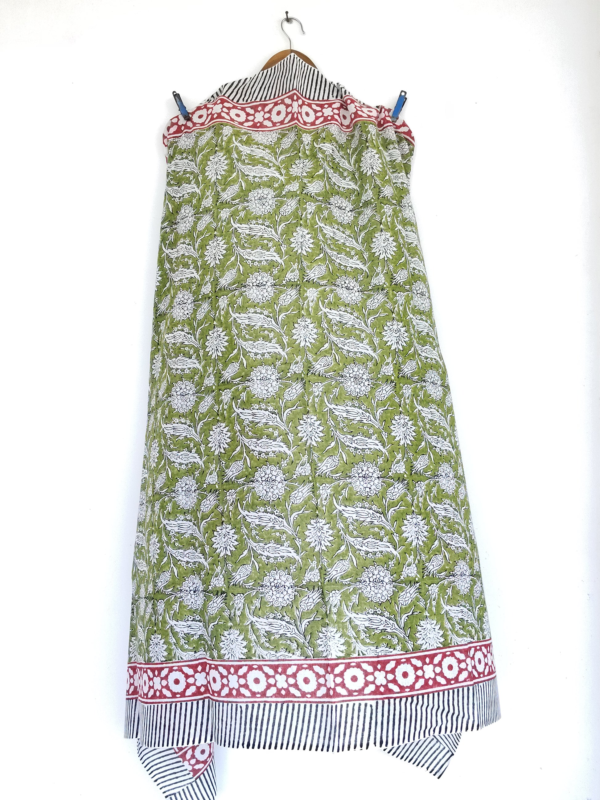  sarong Green fabric with white floral pattern and red border on a white background
