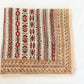 Hand block printed beige and red cotton bandana with tribal motifs, square shape.