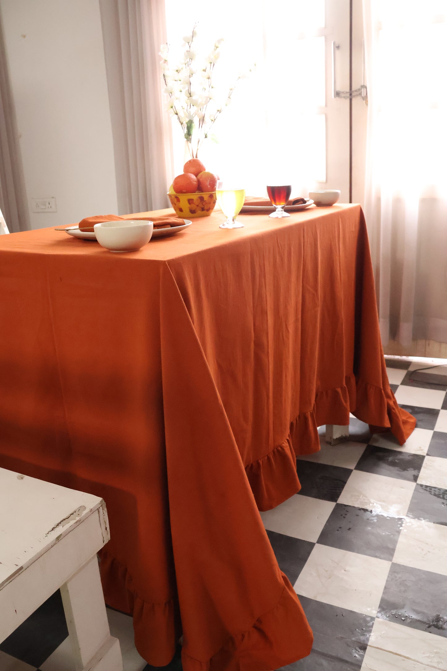 Orange tablecloth on a dining table cover