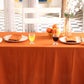 Dining table set with orange tablecloth