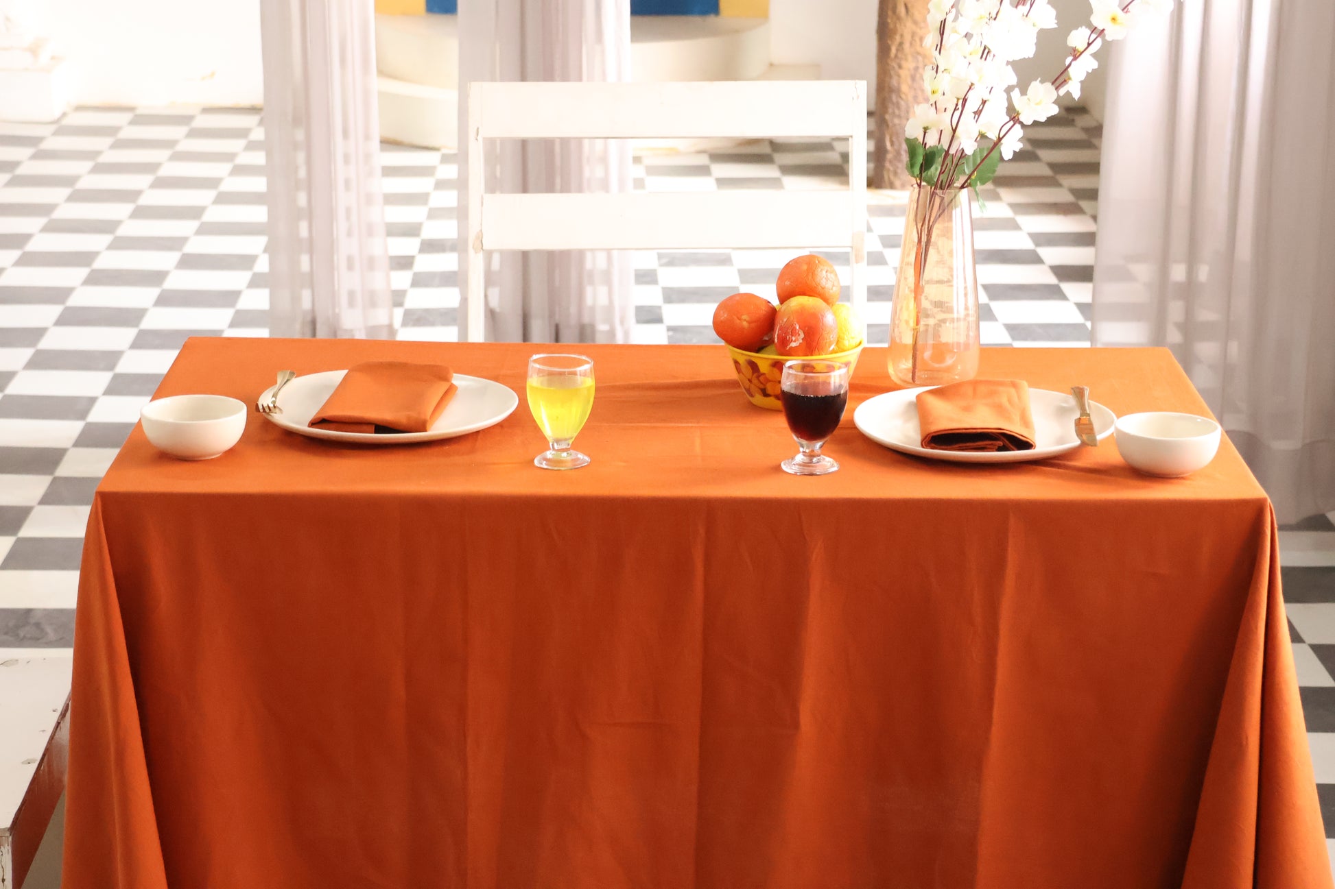Dining table set with orange tablecloth