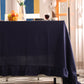 Navy blue curtain partially covering a window with decorative elements.