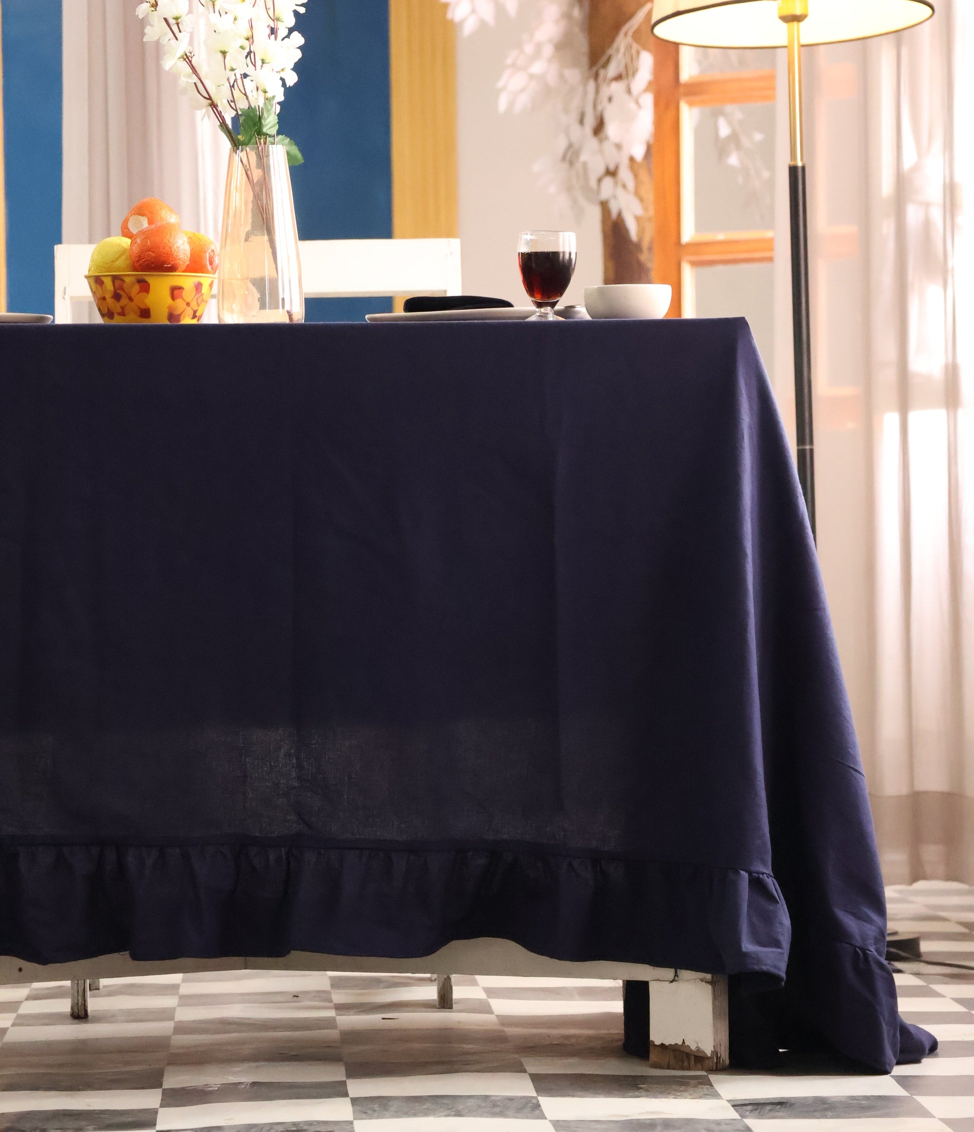 Navy blue curtain partially covering a window with decorative elements.