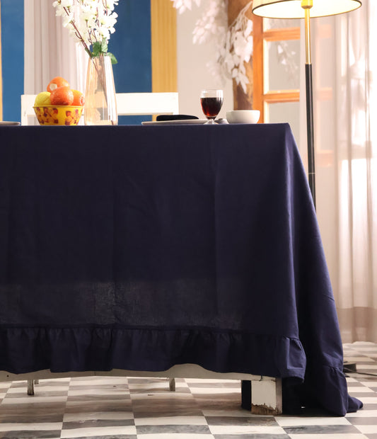 Navy blue curtain partially covering a window with decorative elements.
