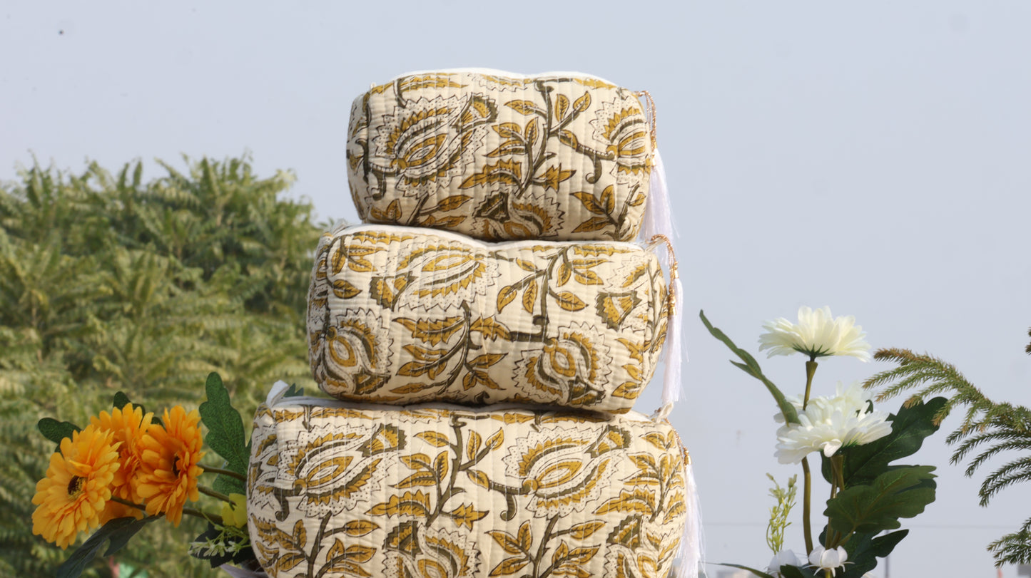 Stack of patterned fabric rolls with flowers in the background