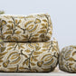 Decorative pillows with floral patterns on a white surface with flowers in the background