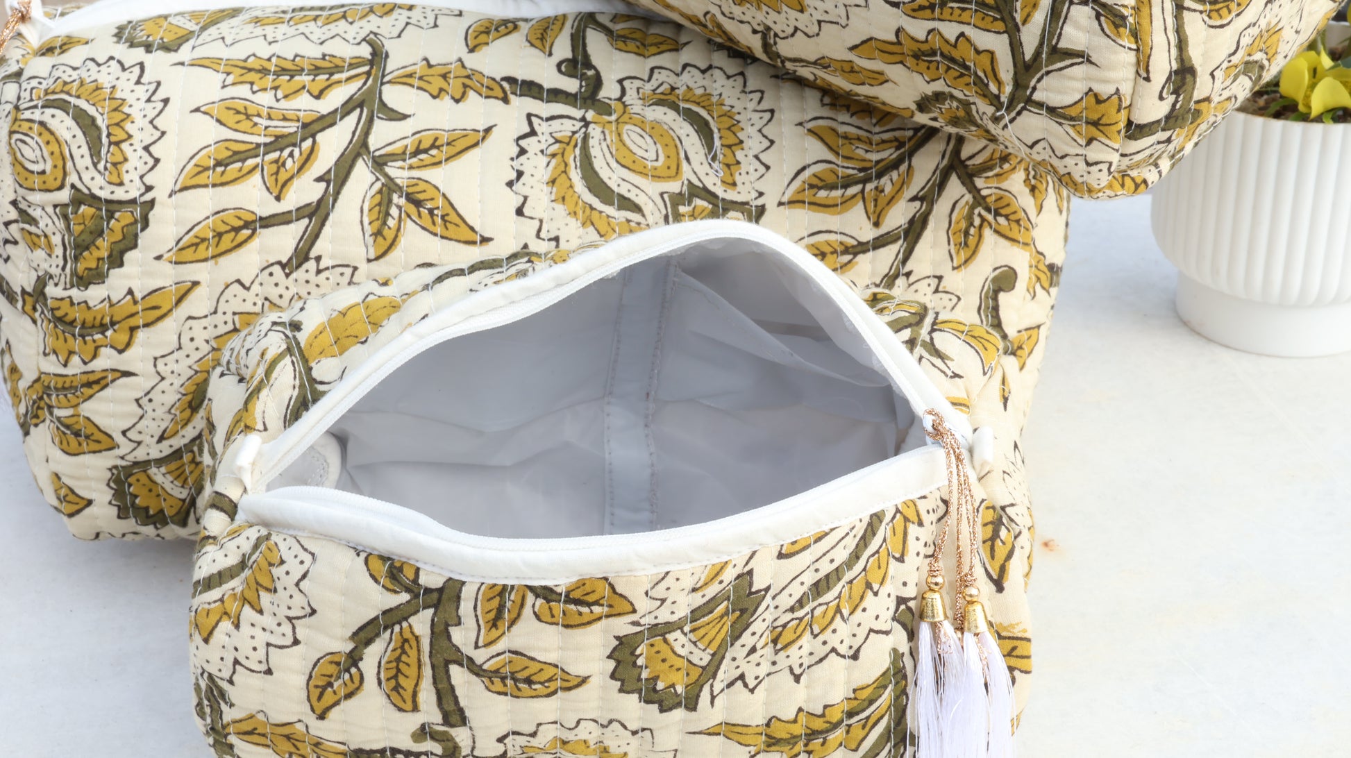 Floral-patterned bag with a white interior on a light background