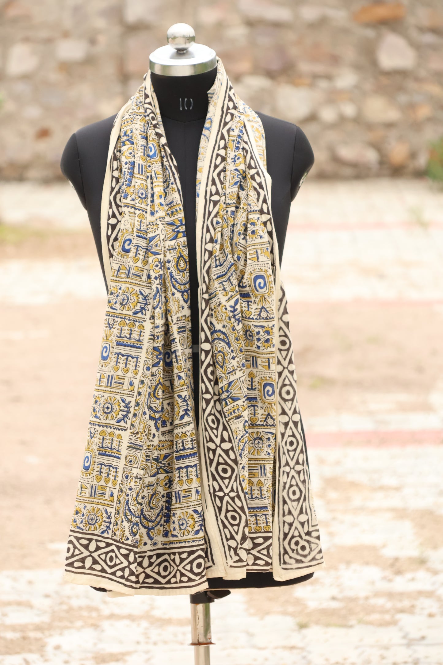 cotton sarong with tribal and geometric motifs in mustard, blue, and black