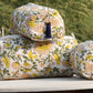 Hand block printed cotton quilted toiletry bag set stacked outdoors with floral design