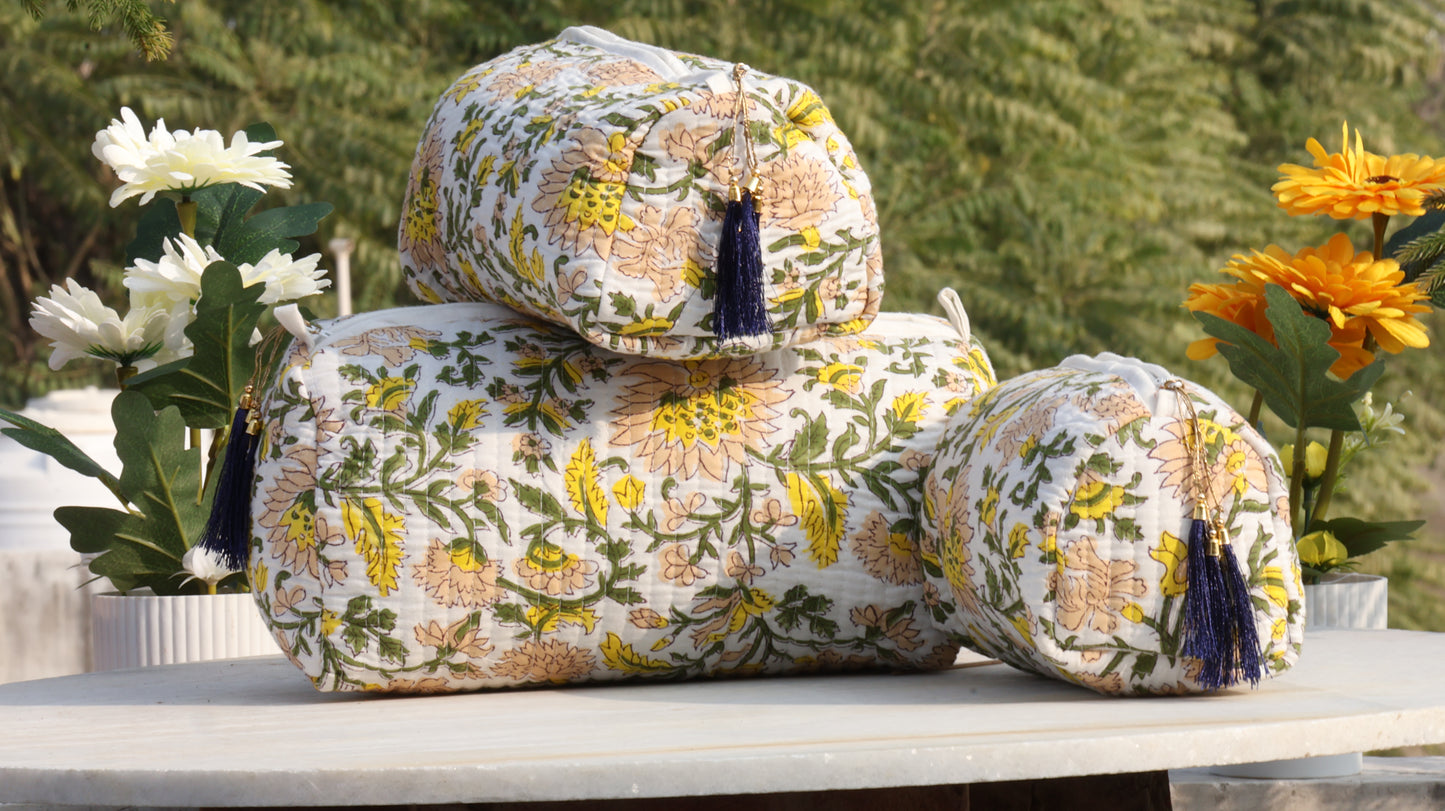 Hand block printed cotton quilted toiletry bag set stacked outdoors with floral design