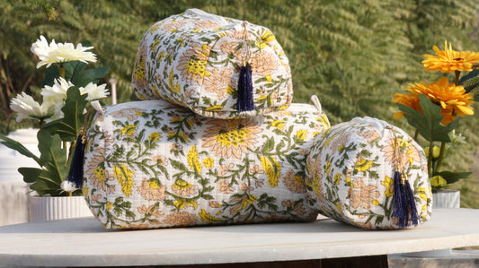 Hand block printed cotton quilted toiletry bag set stacked outdoors with floral design
