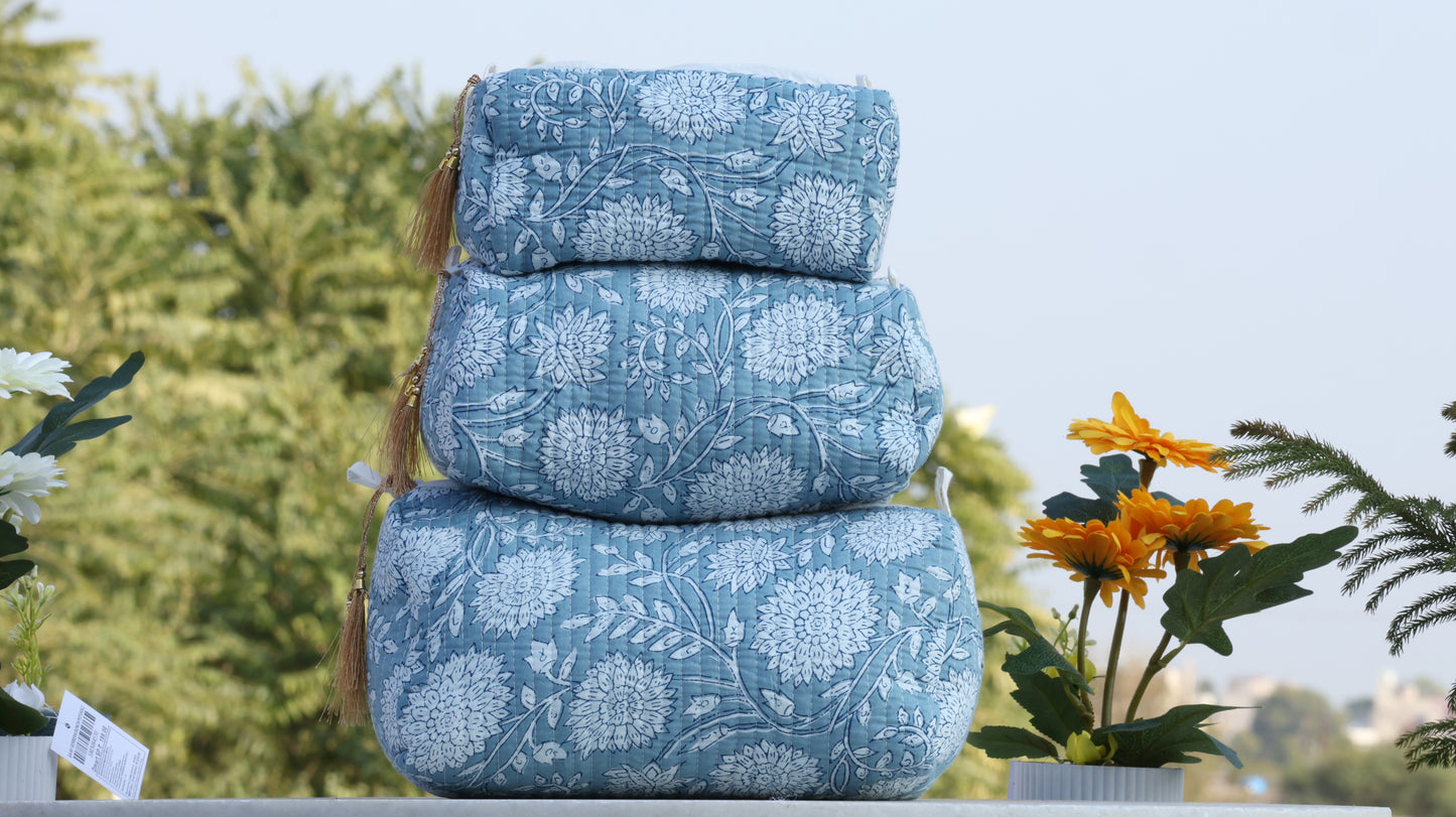 Hand block printed blue and white floral quilted travel bag stacked in three sizes
