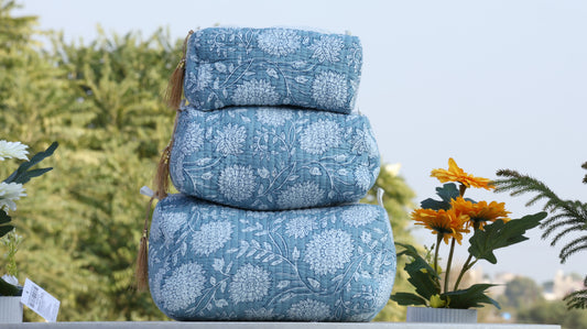 Hand block printed blue and white floral quilted travel bag stacked in three sizes