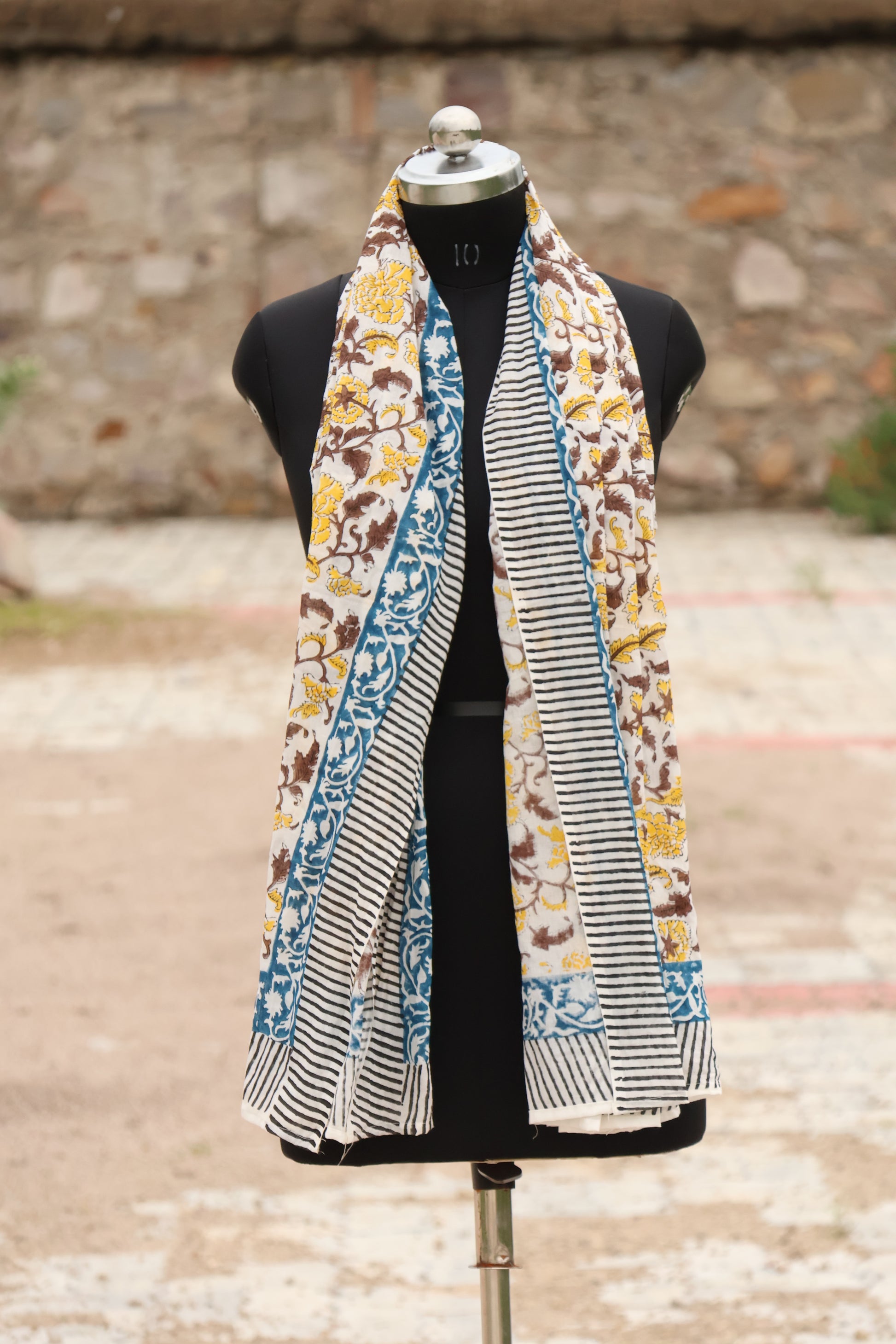 Handblock printed cotton sarong featuring yellow floral motifs, a blue decorative border