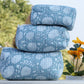 Stack of blue patterned pillows with a blurred natural background