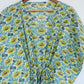 Floral-patterned garment on a hanger against a white background