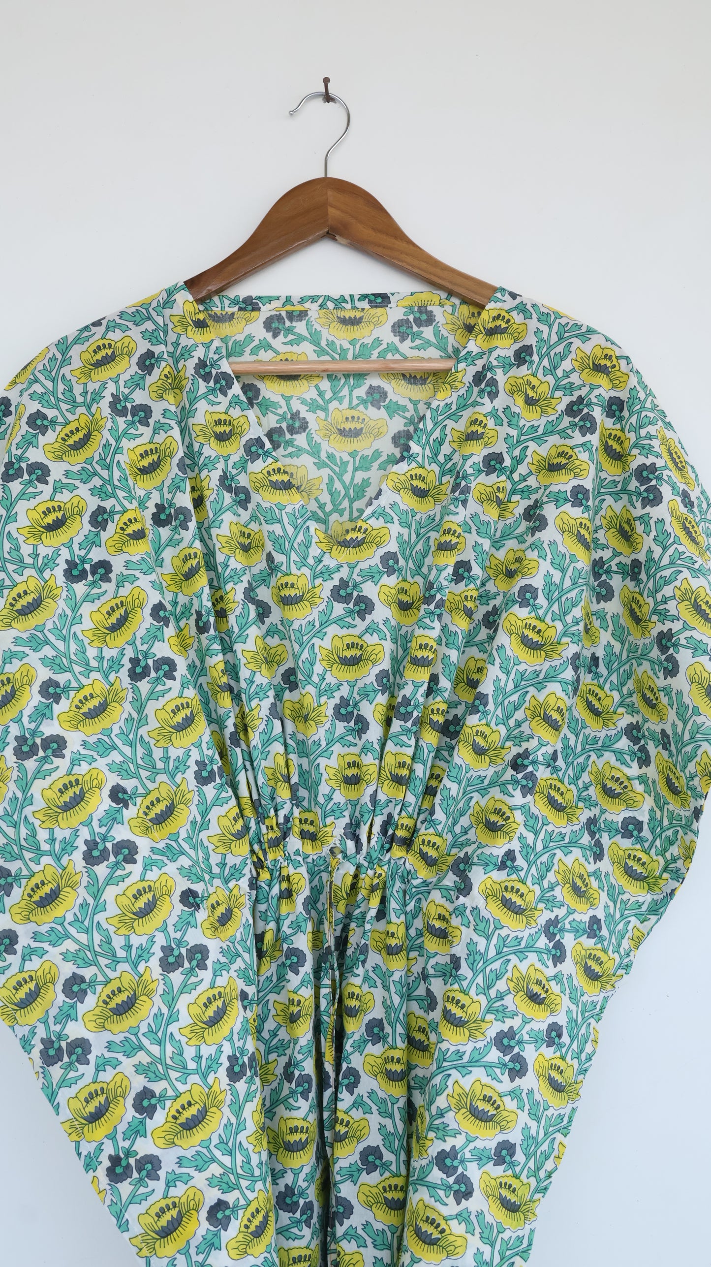 Floral-patterned garment on a hanger against a white background