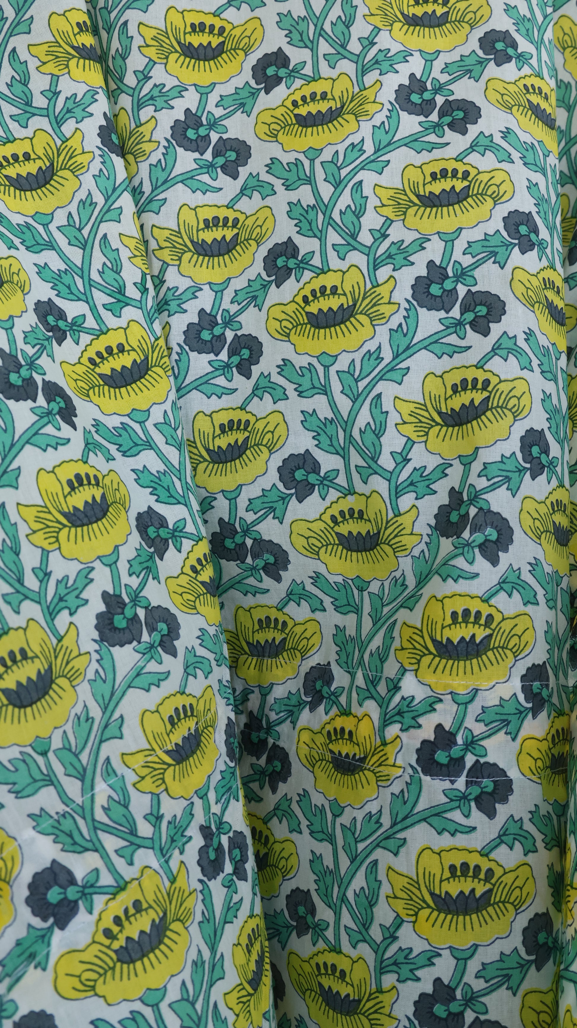 Floral fabric with yellow flowers on a green background