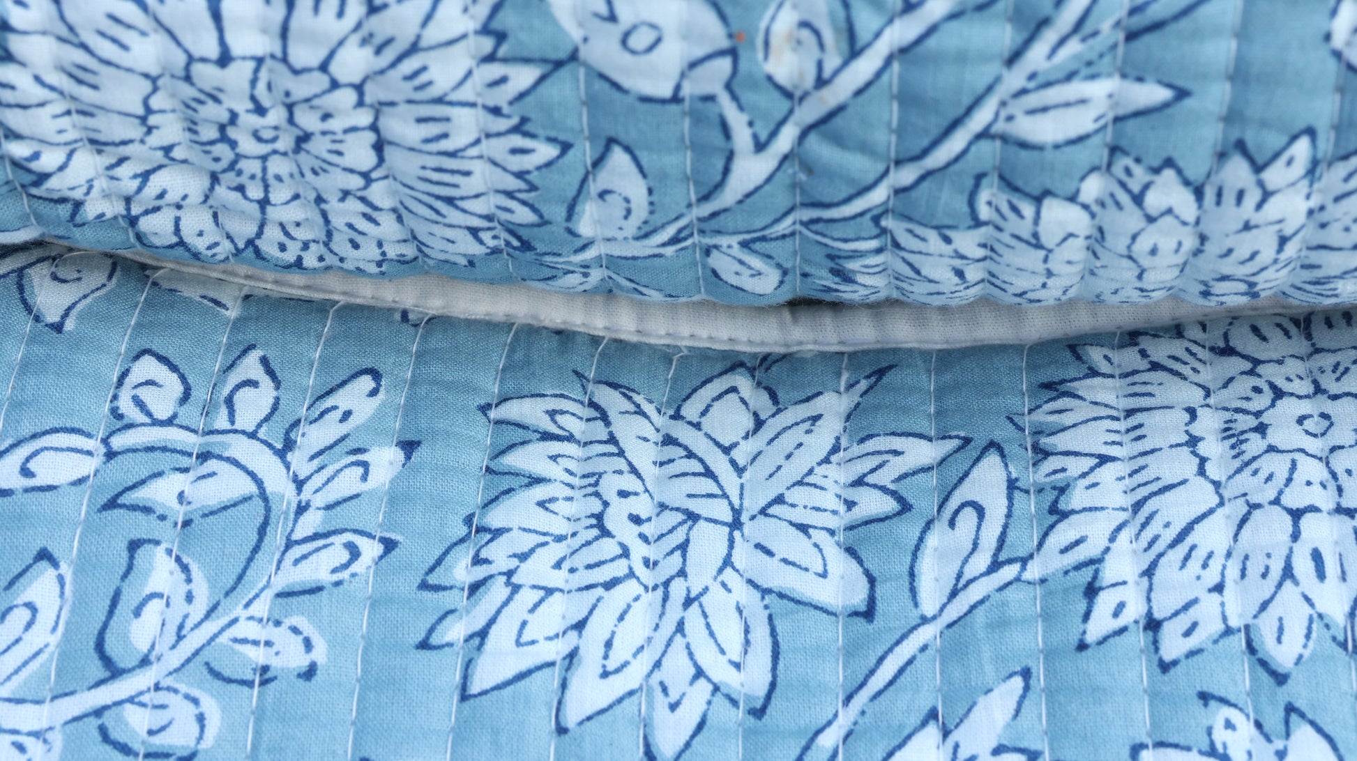 Travel-friendly cotton pouch with white floral motifs and wipeable lining