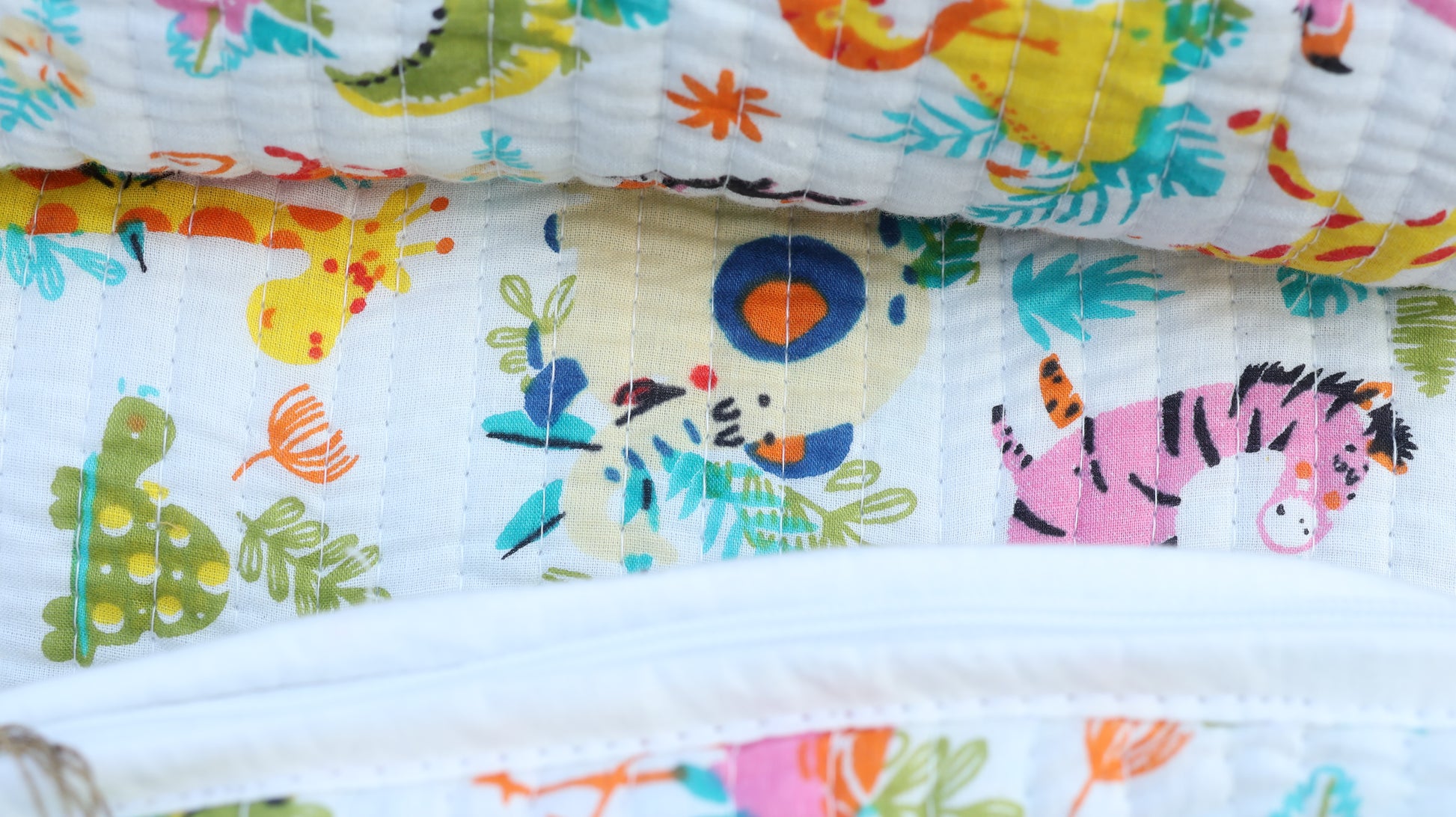 Colorful fabric with animal prints and a spoon on a white background