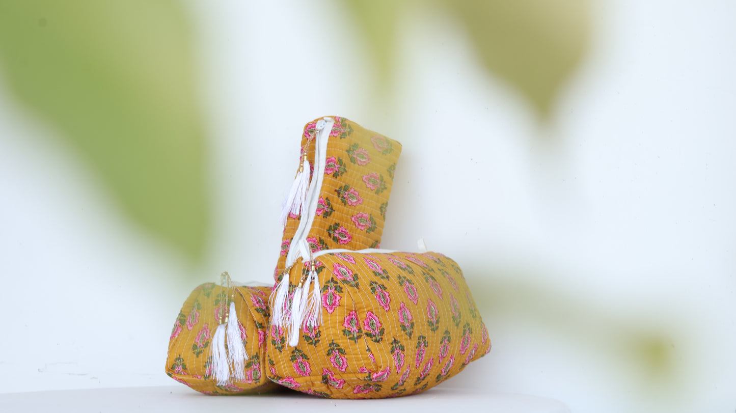 Yellow fabric basket with floral pattern on a blurred green background