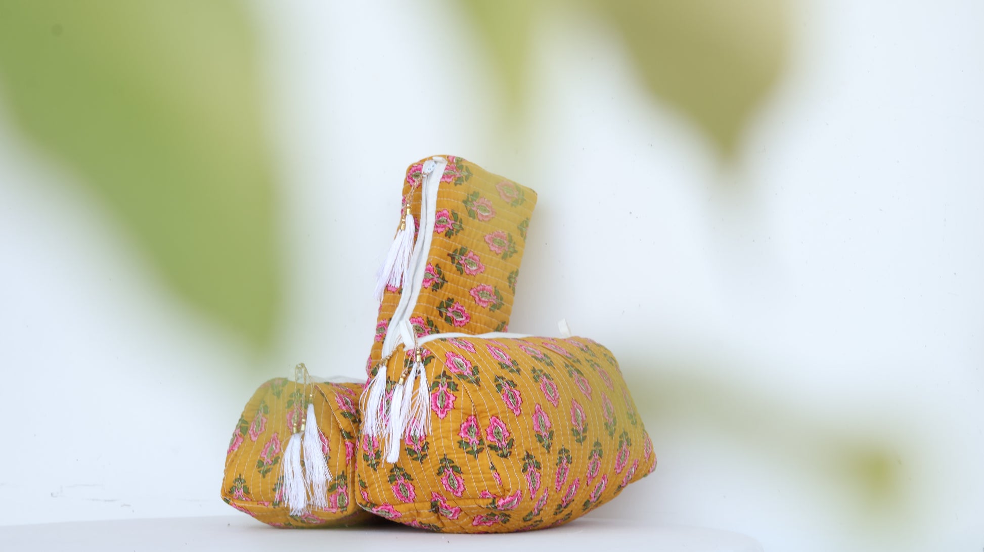 Yellow fabric basket with floral pattern on a blurred green background