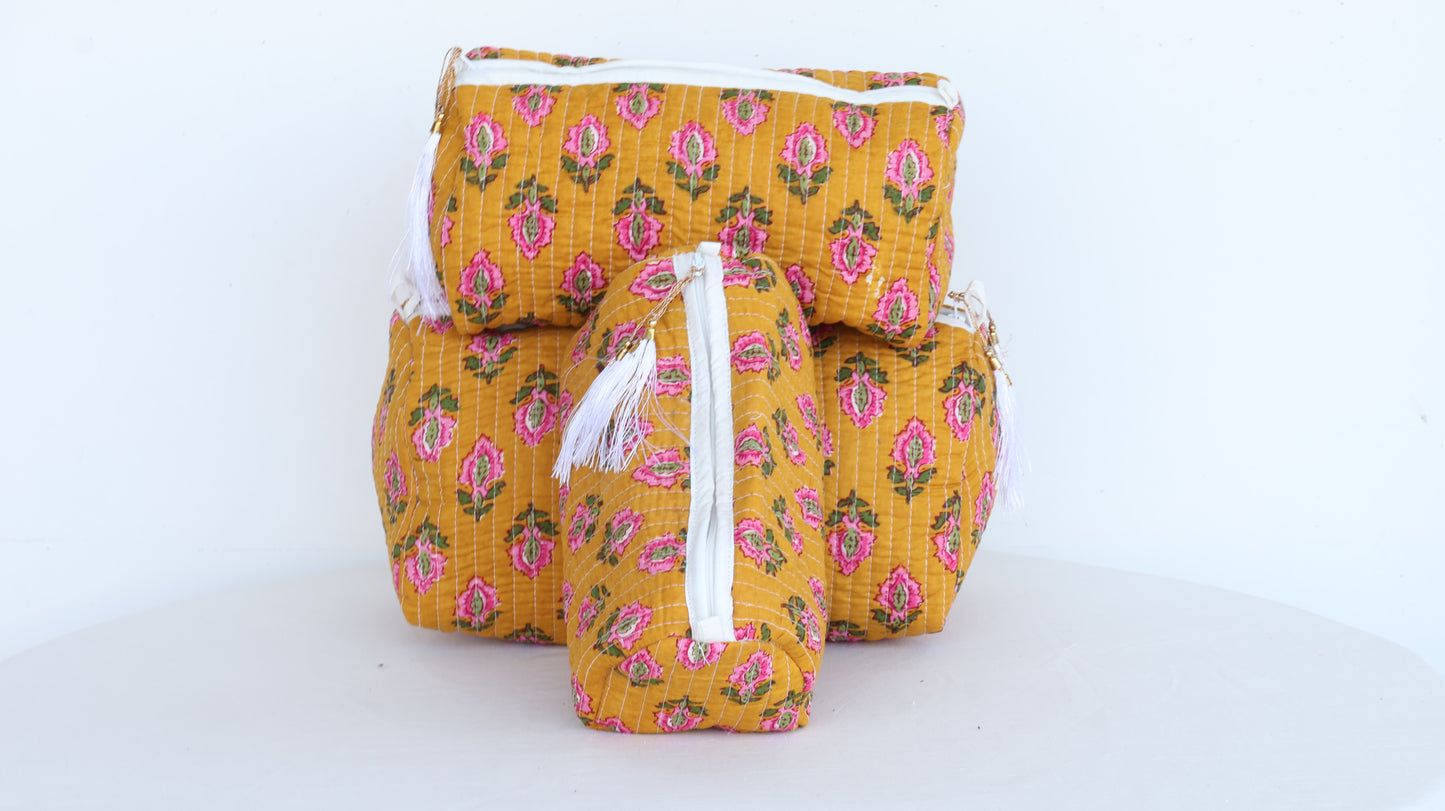 Yellow fabric bags with pink floral pattern on a white background