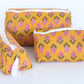 Three yellow fabric pouches with pink floral patterns on a white background