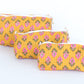Three yellow patterned pouches on a white background