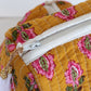 Close-up of a floral-patterned fabric bag with a zipper.