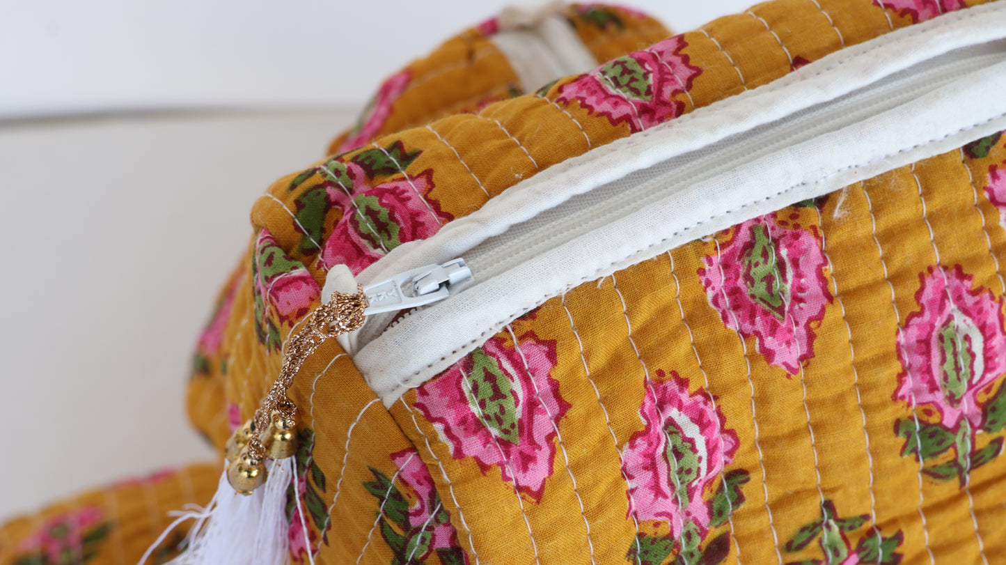 Close-up of a floral-patterned fabric bag with a zipper.