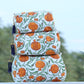 Stack of patterned fabric boxes with tassels on a blurred natural background