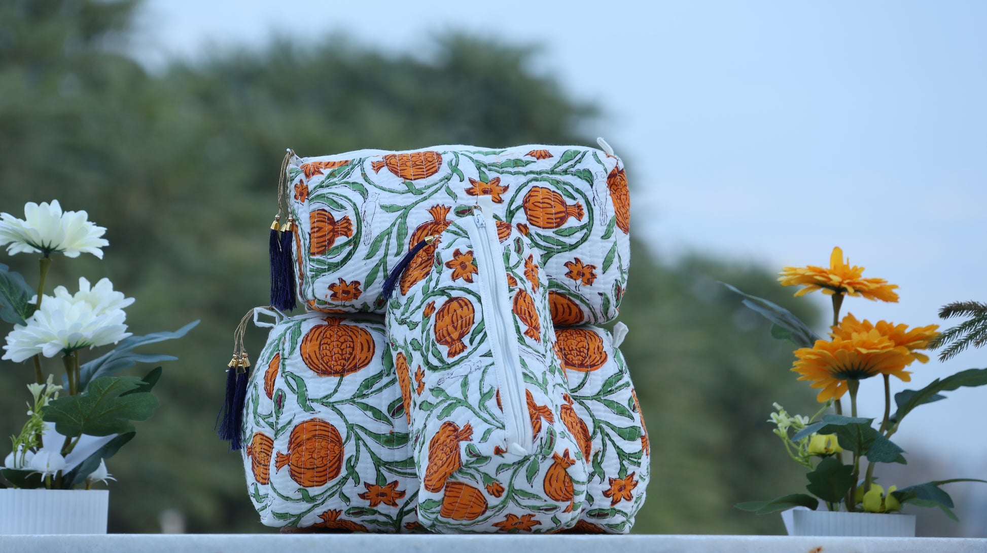 Decorative bag with orange floral pattern on a blurred natural background