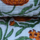Close-up of fabric with orange and green floral pattern