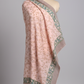 Pink floral patterned sarong on a mannequin against a gray background