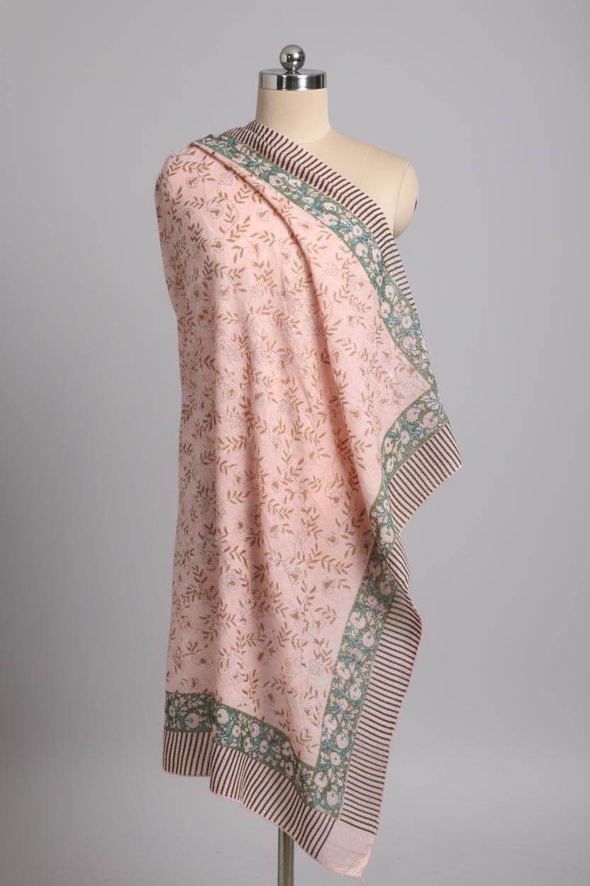 Pink floral patterned sarong on a mannequin against a gray background