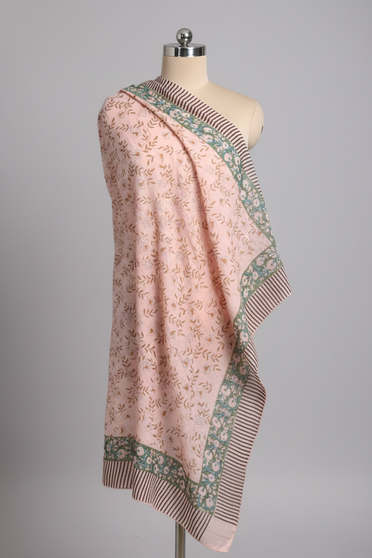 Pink floral patterned sarong on a mannequin against a gray background