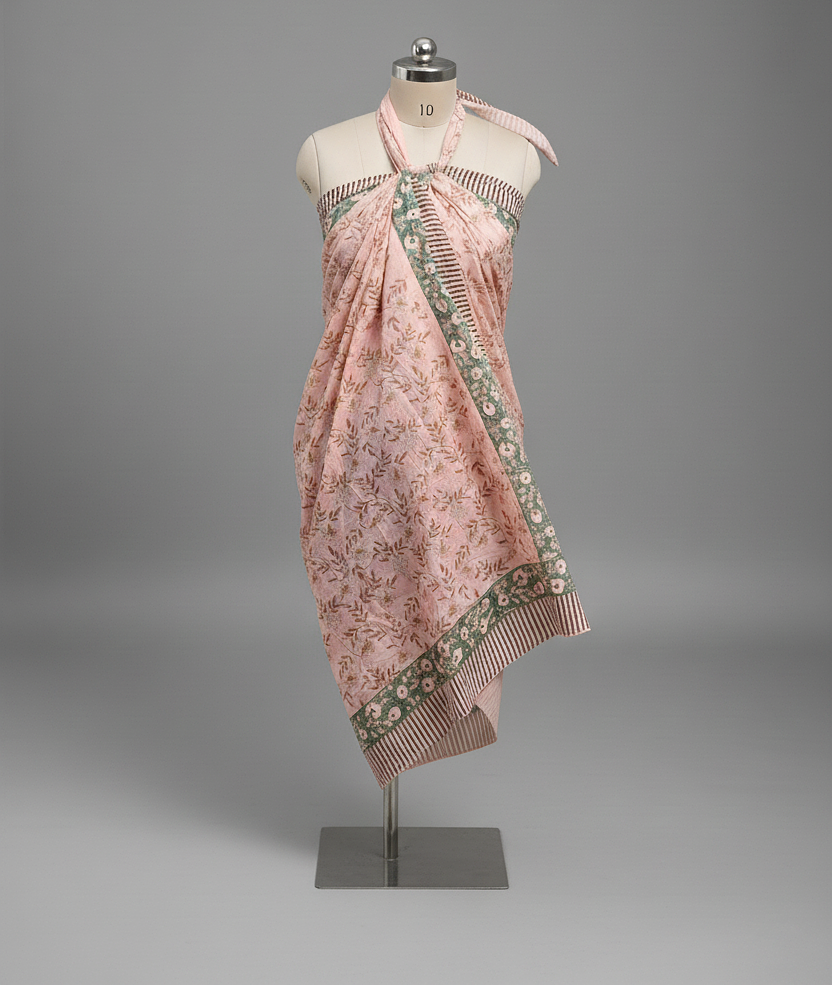 Pink floral dress on a mannequin against a gray background